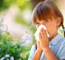 Allergy.little,girl,is,blowing,her,nose,near,spring,tree,in