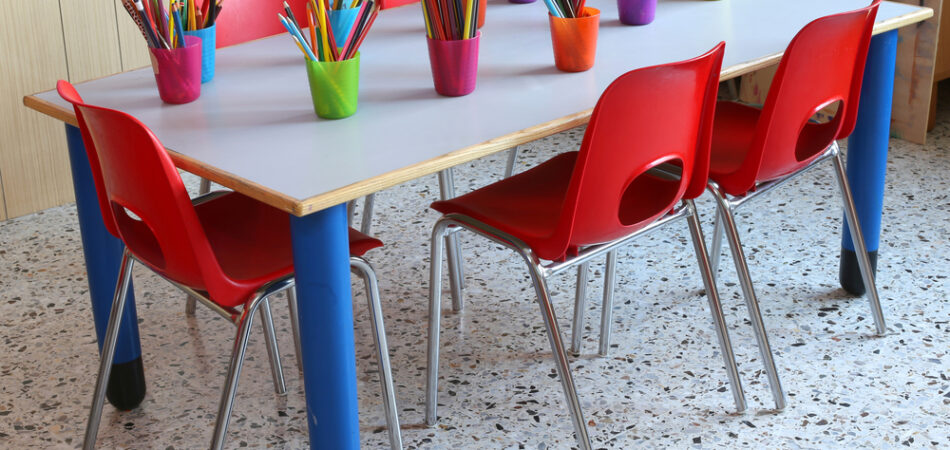 Classroom,of,a,kindergarten,with,red,chairs,and,small,desks