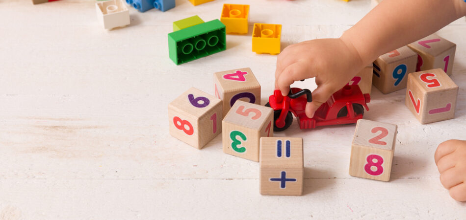 Close,up,of,child's,hands,playing,with,colorful,plastic,bricks