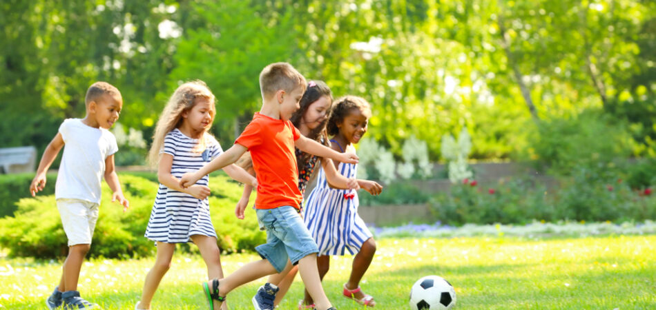 Cute,little,children,playing,football,outdoors